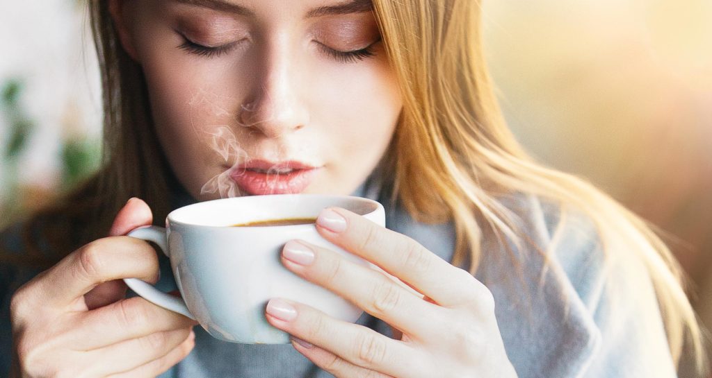 Girl drinking coffee added flavored syrup